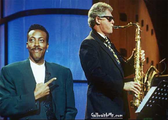 Arsenio Hall (pointing) and Bill Clinton (playing the saxohone)